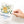 Load image into Gallery viewer, A hand holds the Onderkast Studio Thinking of You Flowers Greeting Card, featuring a striped vase with yellow and white flowers. The card says Thinking of you in script—an elegant floral design for any occasion.