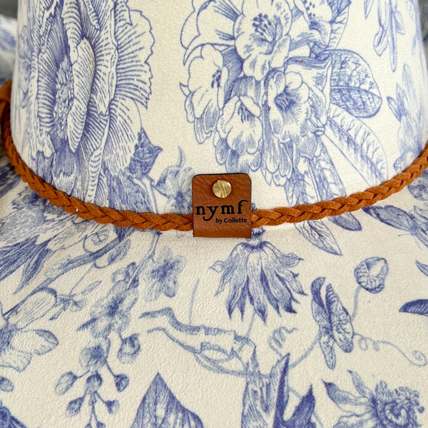 611fc05e3c4ce80992caae23_blue-chinoiserie-ivory-pinched-cowboy-back-detail_1776441609859.jpg