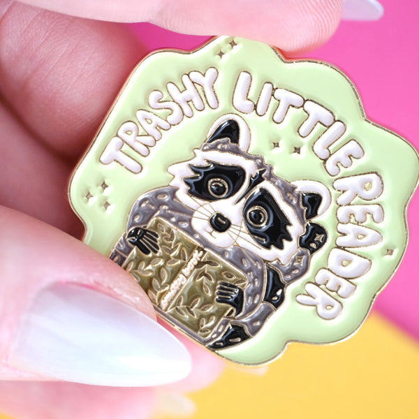 611fc05e3c4ce80992caae23_trashy-little-reader-racoon-pin-2_1790864758936.jpg